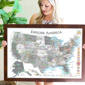 May include: A framed map of the United States with the title "Explore America". The map is detailed and includes various points of interest throughout the country.