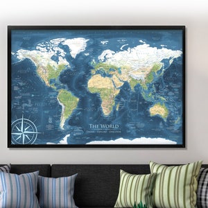 May include: A framed world map with a blue background and green and brown landmasses. The map is titled "The World: Dream. Explore. Discover."