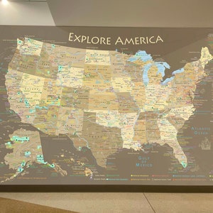 May include: A detailed map of the United States with state borders, major cities, and national parks. The map is labeled "Explore America" and includes a key with symbols for different types of parks and landmarks.