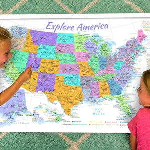 May include: Two children are looking at a large map of the United States. The map is colorful and shows the states in different colors. The map is titled "Explore America".