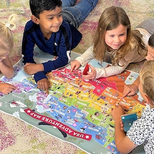 May include: Four children are gathered around a large, colorful map of the United States. The map features illustrations of animals and landmarks from each state. The children are pointing at different parts of the map, learning about the country.