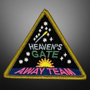 May include: Embroidered patch in a triangular shape with a black background and gold trim. The patch features the text "HEAVEN'S GATE AWAY TEAM" with a sun graphic and stars.