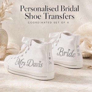 Op de afbeelding: Een paar witte high-top canvas sneakers met zilveren glitterteksttransfers. De ene schoen toont 'Mrs Davis' met een hartje, de andere 'Bride' met een hartje en de datum '04 10 26'. De tekst luidt 'Personalised Bridal Shoe Transfers'.