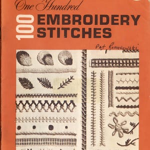 May include: An orange book cover titled "One Hundred Embroidery Stitches." The cover displays various embroidery stitch examples in black and white. The author's name, Pat Romanowski, is also visible.