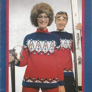 May include: A vintage image of two people wearing matching red, white, and blue ski sweaters. The sweaters have a geometric pattern. One person wears a fur hat and glasses, the other wears ski goggles and holds a pair of skis.
