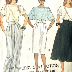 May include: A vintage sewing pattern featuring three women's clothing designs. The first design is a white blouse with a ruffled neckline and a pair of striped trousers. The second design is a light blue blouse with a ruffled neckline and a white skirt. The third design is a white blouse with a black skirt. The pattern is titled "The Fabric Collection" and includes the text "No Exchange or Return on Paper Patterns".