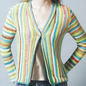 May include: A striped cardigan with a V-neck and a single button fastening. The cardigan is made from a soft, colourful yarn and has a relaxed fit.