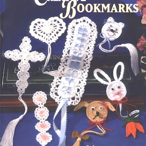 May include: A book cover featuring 14 crochet bookmark designs. The cover is blue with white crochet designs and the title "Creative Bookmarks" in white text. The book is by Jo Ann Maxwell.