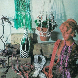 May include: A collection of macrame items, including a hanging plant holder, a bottle cover, a necklace, and a belt. The plant holder is made of white cord and has a brown pot with a green plant inside. The bottle cover is made of white cord and is wrapped around a clear glass bottle. The necklace is made of red cord and has red beads. The belt is made of white cord and has a braided design.