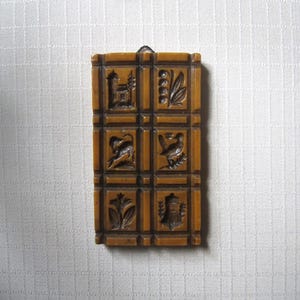 May include: A set of three ceramic mugs with a speckled, cream-colored glaze. Each mug features a different hand-painted design: a sun, a moon, and a star. The mugs have a simple, modern design with a rounded shape.