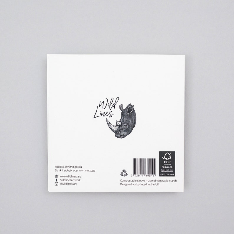May include: A white greeting card featuring a detailed black and white illustration of a rhinoceros head. The card has the text "Wild Lines" and includes the website and social media handles. The card is designed and printed in the UK.