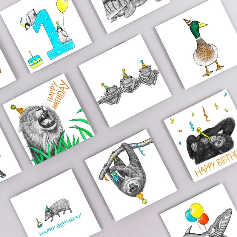 May include: A set of 10 greeting cards featuring various animals wearing party hats. The cards are white with black and white illustrations of a lion, a sloth, a turtle, a duck, a paca, a gorilla, three frogs, and a whale. The cards have the text "Happy Birthday" on them.