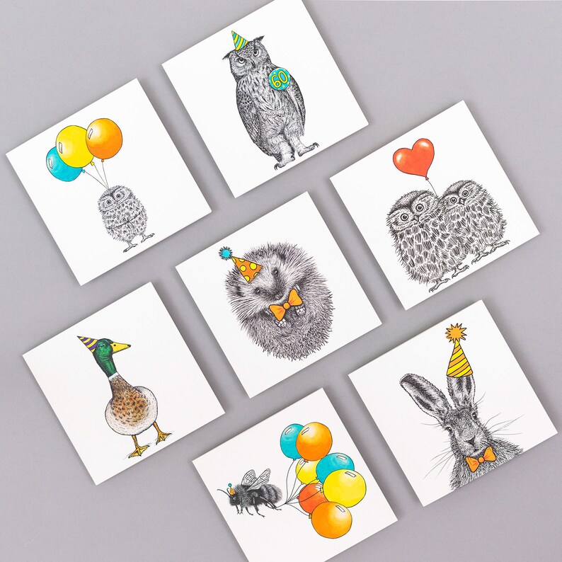 May include: Set of 8 greeting cards featuring various animals wearing party hats and holding balloons. The animals include an owl, a hedgehog, a duck, a rabbit, a bee, and two owls. The cards are blank inside for writing a message.