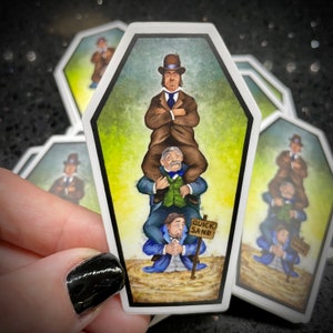 May include: Three men in vintage clothing are stacked on top of each other, sinking into quicksand. The top man is wearing a brown suit and a hat, the middle man is wearing a blue suit and a vest, and the bottom man is wearing a blue suit and a white shirt. A sign reads "Quick Sand".