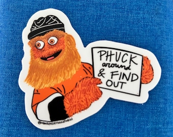 May include: A sticker featuring a cartoon character with orange fur, wearing a black hat and orange shirt. The character holds a sign that reads "PHUCK around & FIND OUT". The sticker has a white border and is on a blue background.