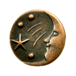 May include: A copper-toned metal button featuring a crescent moon design and a star. The moon has a face and the background is dark with three small circles.