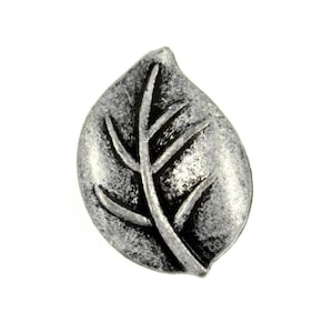 May include: A silver leaf-shaped button with a detailed vein pattern. The button has a slightly textured surface and a distressed finish.