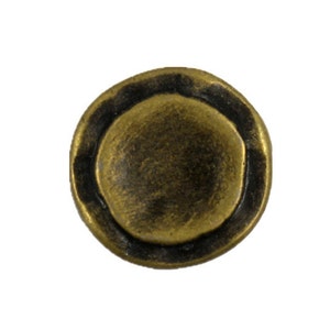 May include: A round, gold-toned metal button with a raised, slightly domed center. The button has a dark brown rim around the edge.