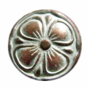 May include: A round, silver-colored button with a raised, embossed flower design. The flower has five petals and a center circle. The button has a slightly aged, antique look.