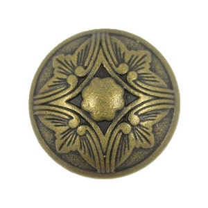 May include: A round, antique gold-toned metal button with a decorative floral design.