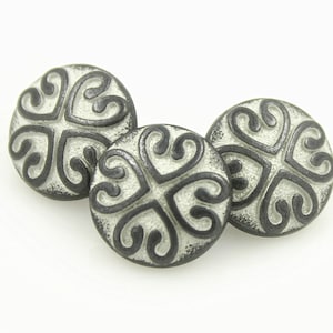 May include: Three black and white decorative buttons with a swirling pattern. The buttons are round and have a raised design.