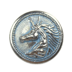 May include: A silver-toned metal button with a blue enamel background featuring a detailed unicorn design.