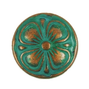 May include: A round, copper-toned button with a green, four-leaf clover design. The clover has a copper-toned center.