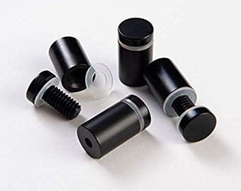 May include: Five black metal standoffs with a silver ring around the top. The standoffs are used to elevate and secure objects.