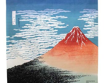 Puede incluir: Una estampa en madera del Monte Fuji, una famosa montaña japonesa, con un pico rojo y un cielo azul con nubes blancas. La estampa se titula "Treinta y seis vistas del Monte Fuji" por Katsushika Hokusai.