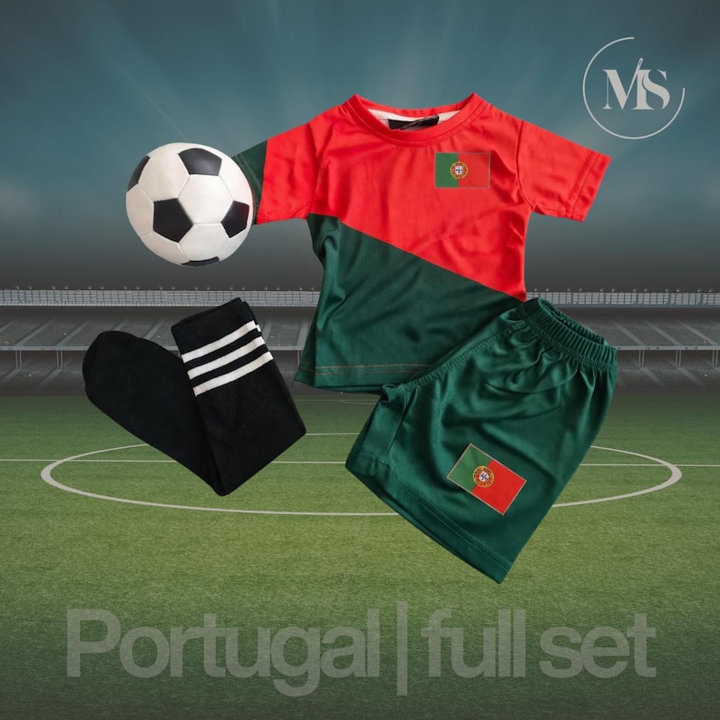 May include: A soccer-themed outfit set featuring a red and green jersey and shorts with the Portuguese flag, a black and white soccer ball, and black socks with white stripes. The text "Portugal | full set" is at the bottom.