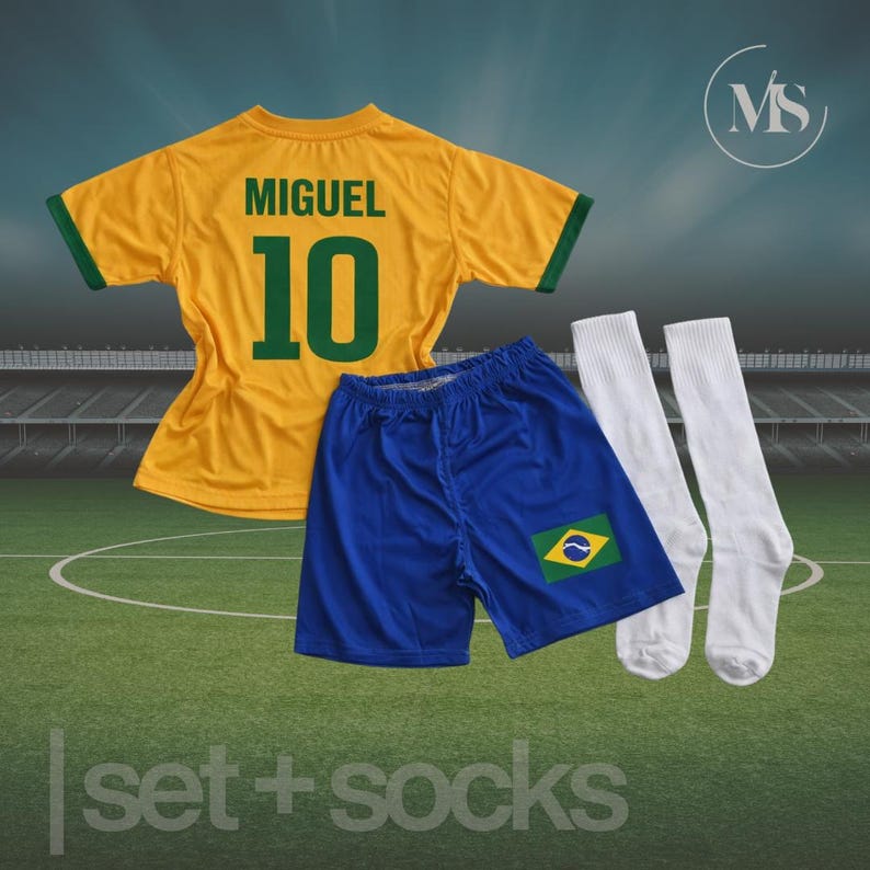 May include: A yellow soccer jersey with green trim, the name "MIGUEL" and the number "10" in green. Includes blue shorts with a Brazilian flag patch and white socks. The words "set + socks" are at the bottom.