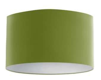 May include: A cylindrical lampshade in a solid olive green color. The interior is white, creating a contrast with the exterior. The lampshade has a curved top and bottom.