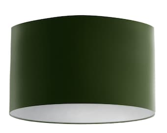 May include: A dark green drum lampshade with a white interior.
