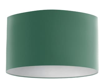 May include: A green lampshade with a white interior. The lampshade is cylindrical and has a smooth surface.