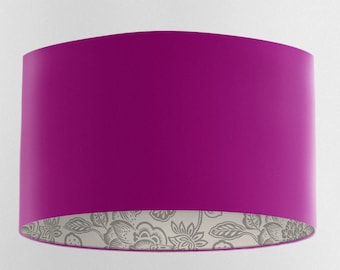 May include: A magenta lampshade with a floral pattern on the inside.
