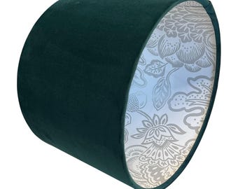 May include: A dark green velvet lampshade with a white floral pattern on the inside.