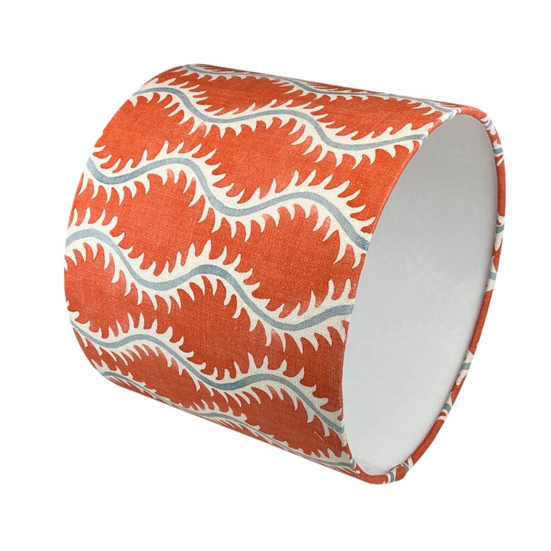 May include: Orange and blue patterned lampshade with a wavy design.