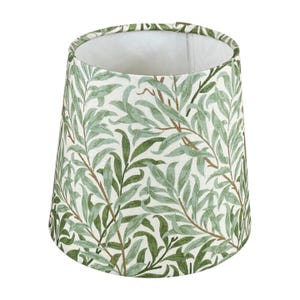 May include: A lampshade with a botanical design. The shade has a cream-coloured background with a repeating pattern of green leaves and brown stems. The interior of the shade is white, offering a clean contrast to the exterior design.