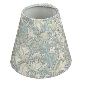 May include: A small, tapered lampshade with a floral pattern. The shade features a light blue background with a repeating design of stylized white and beige flowers and foliage. The interior is a solid light gray.