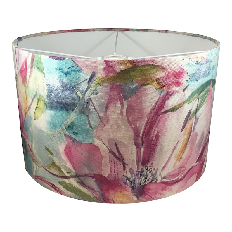 May include: A round lampshade with a floral print in shades of pink, blue, green, and yellow. The print resembles watercolor paintings of flowers.
