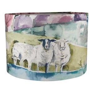 May include: A watercolour painting of a rural landscape with two sheep standing in a field. The sheep are white with black faces and are standing in front of a blue pond. The background is a watercolour painting of a green field, purple hills, and pink trees.
