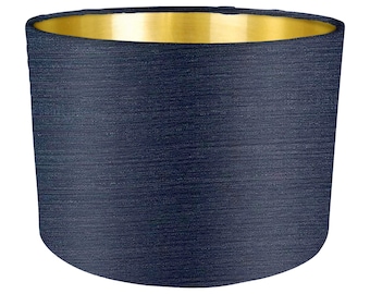 May include: A dark blue lampshade with a gold top. The lampshade has a textured fabric finish.