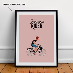 May include: A black framed poster with a pink background featuring a woman riding a bicycle. The text "THE passionate RIDER" is at the top of the poster.