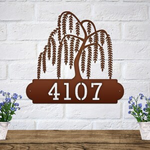 Weeping Willow House Numbers Plaque shown in Candy Copper with Example Street Numbers on White Brick Wall