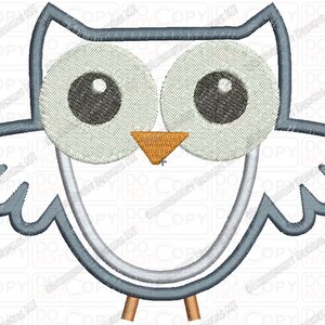 May include: A blue and white embroidered owl with large eyes and a small orange beak. The owl is outlined in blue and has a white body.