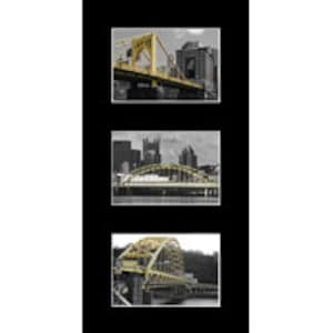 May include: A black and white photo of a yellow bridge over a river with buildings in the background.