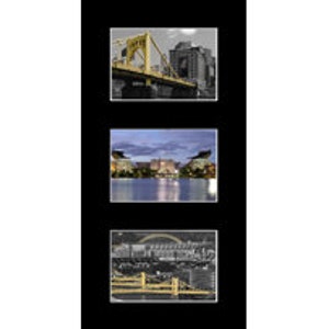 May include: A black and white photo of a bridge over a river with buildings in the background. The bridge is yellow and has a distinctive arch. The photo is in a black frame.