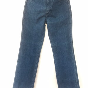 May include: A pair of dark blue denim jeans with a straight leg fit.
