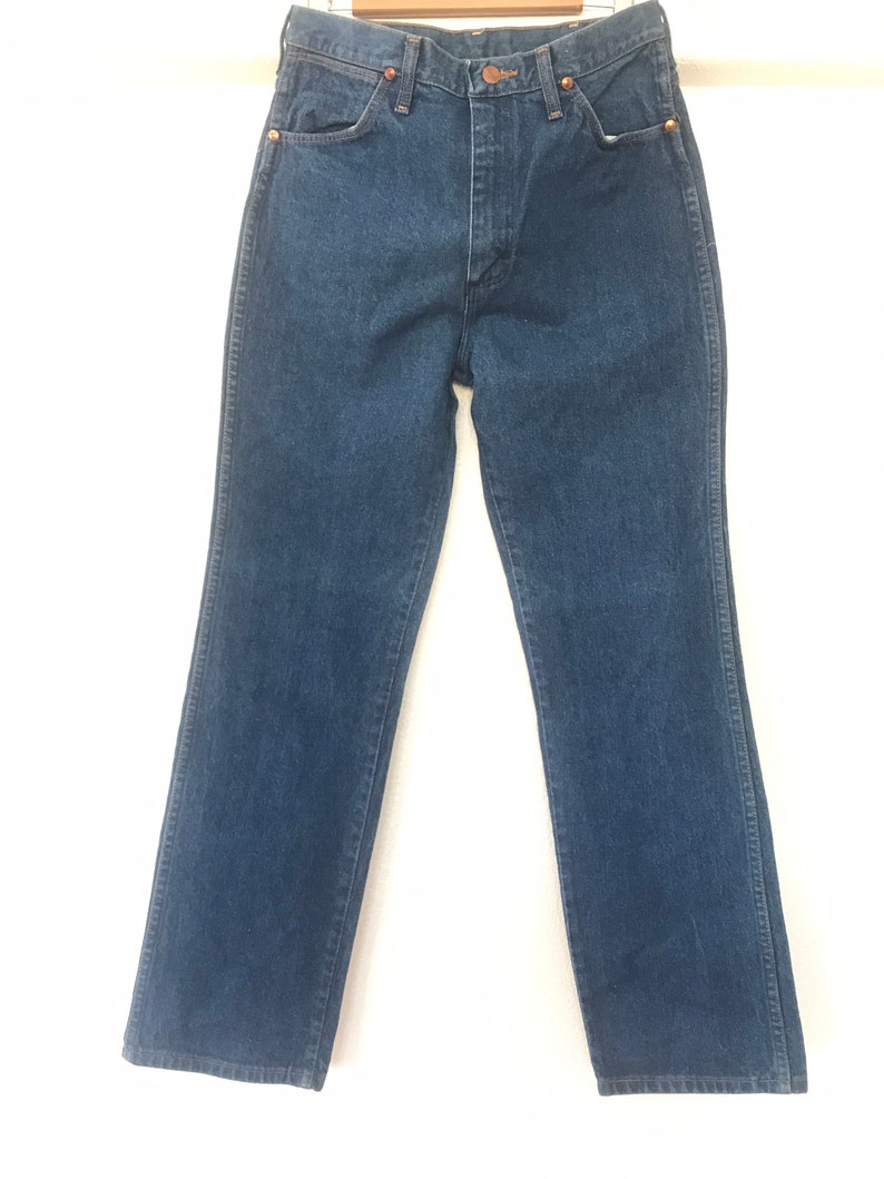 May include: A pair of dark blue denim jeans with a straight leg fit.