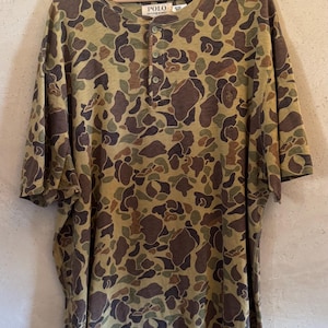 May include: A set of three ceramic mugs with a speckled, matte finish. The mugs are in shades of cream, light gray, and dark gray. Each mug has a simple, minimalist design, perfect for coffee or tea.